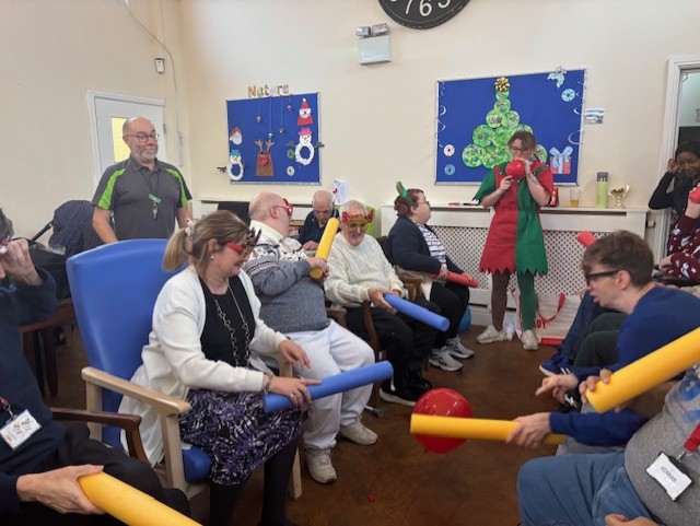 Friends sharing a warm hug at Edmund Street Activity Centre